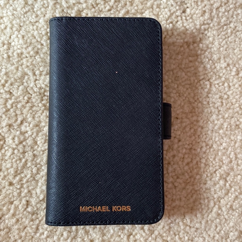 This black Michael Kors 5S iPhone case with slots is perfect for on the go.